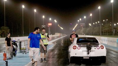 At Yas Marina Circuit, racer Taleb Ahmed and his team see their car off to face a competitor in the drag races. Ravindranath K / The National