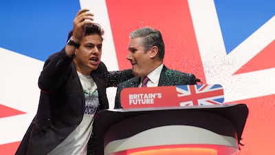 The protester puts his arm around the Labour leader. PA