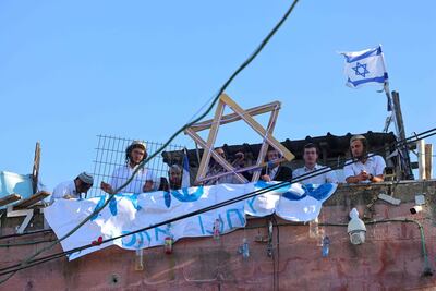 Israeli settlers on the roof of a house in Sheikh Jarrah. AFP