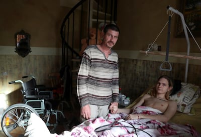 Mr Bocharov and his injured son Vikentiy at their house outside Moscow. Mr Bocharov, 46, is the owner of four hair salons, which closed their doors at the end of March due to Covid-19 lockdown measures. Reuters