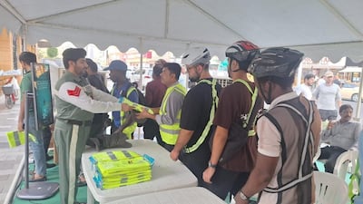 Safety equipment are also distributed to workers in the Naif area. Photo: Dubai Police