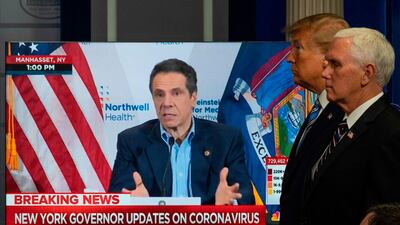 US President Donald Trump and US Vice President Mike Pence look on as a video plays of New York Governor Andrew Cuomo giving a press conference. AFP