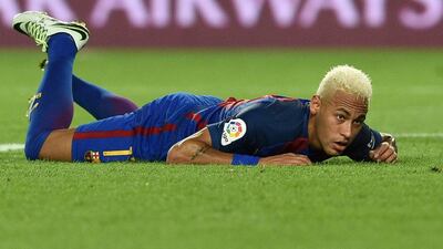 Neymar lies on the pitch after missing a goal scoring chance. Lluis Gene / AFP