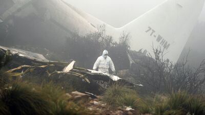 Forensic experts inspect the wreckage of a C-130 Hercules aircraft on Mount Fertas in the Oum El Bouaghi region, about 320 kilometres from the Algerian capital Algiers, on February 12, 2014. The military aircraft carrying 78 people crashed in the mountainous north-east region of the country on Tuesday, leaving a sole survivor in one of the country’s deadliest air disasters, the defence ministry said. Farouk Batiche / AFP photo