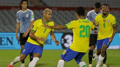 Brazil's Richarlison, left, celebrates with teammates Roberto Firmino and Gabriel Jesus after scoring against Uruguay during their 2022 World Cup South American qualifier. AFP