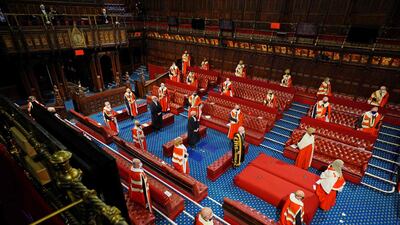 Members of the House of Lords stand socially distanced as they await the arrival of Queen Elizabeth. AFP
