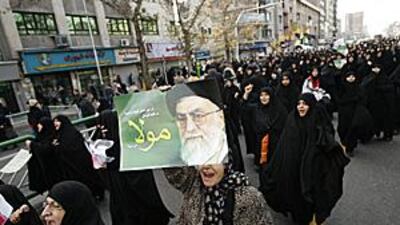 Female demonstrators march during yesterday's pro-government rally in Tehran.