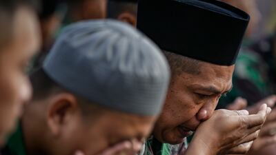 A soldier's reaction during a mass prayer for the victims, outside Kanjuruhan Stadium on October 4. EPA