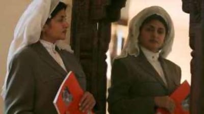Hatoon Ajwad al Fassi, an expert on the rights enjoyed by women in a pre-Islamic Arabian kingdom, poses with her book on the subject.