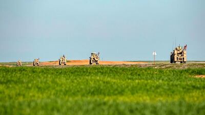 US military armoured vehicles patrol near the town of Tal Tamr along the M4 highway in the northeastern Syrian Hasakeh province, near the border with Turkey. AFP