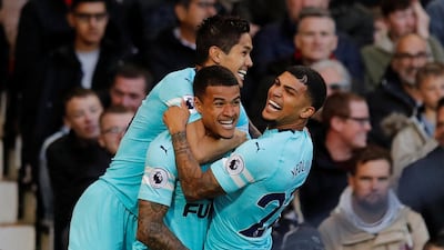 Newcastle United's Kenedy celebrates scoring their first goal with DeAndre Yedlin and Muto. Reuters