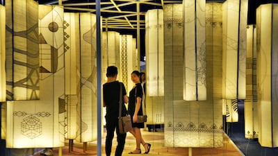 A man photographs a woman at 'Qissa Ghar', India's contribution to Abwab at Dubai Design District. Shruti Jain / The National