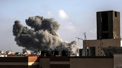 Smoke rises from a building after an Israeli air strike in central Gaza City killed at least two Palestinians on 14 July 2018. Haitham Imad / EPA