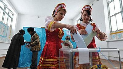Kazakh women in tradition dress vote at a polling centre in the village of Karasu, in north-west Kazakhstan yesterday.