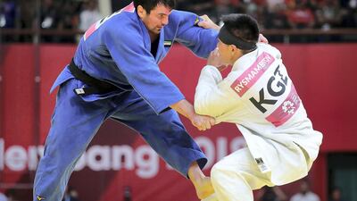 Victor Scvortov, in blue, on his way to win the judo bronze medal from Bettor Rysmambetov of Kyrgyzstan at the Asian Games in Jakarta. UAENOC