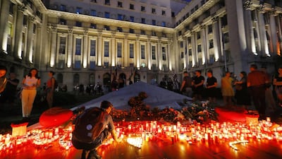 A Romanian man kneels to light a candle at the end of a protest against the way Romanian authorities handled the kidnapping of a 15-year old girl, believe to have been killed in the southern city of Caracal, in front of the Interior Ministry Headquarters, in Bucharest, Romania. The teenage girl managed to call the 112 emergency number three times. EPA