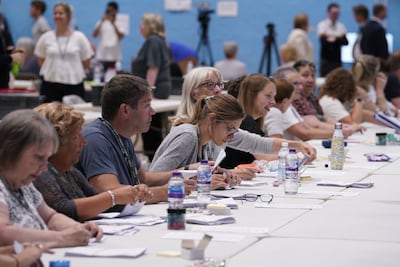 Postal votes are counted at the Lords Meadow Leisure Centre, in Crediton, Devon, for the Tiverton and Honiton by-election in June. PA