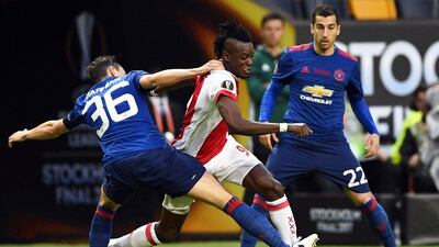 Ajax forward Bertrand Traore, centre, in action against Matteo Darmian, left, and Henrikh Mkhitaryan of Manchester United. Georgi Licovski / EPA