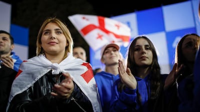 Supporters of the ruling Georgian Dream party celebrate after exit poll results in Tbilisi. The party's Prime Minister Irakli Kobakhidze has rejected claims of election rigging, while the country's president accused his supporters of falsifying the results. EPA