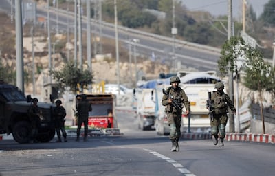 Israeli soldiers block a road during an operation in the occupied West Bank. Reuters