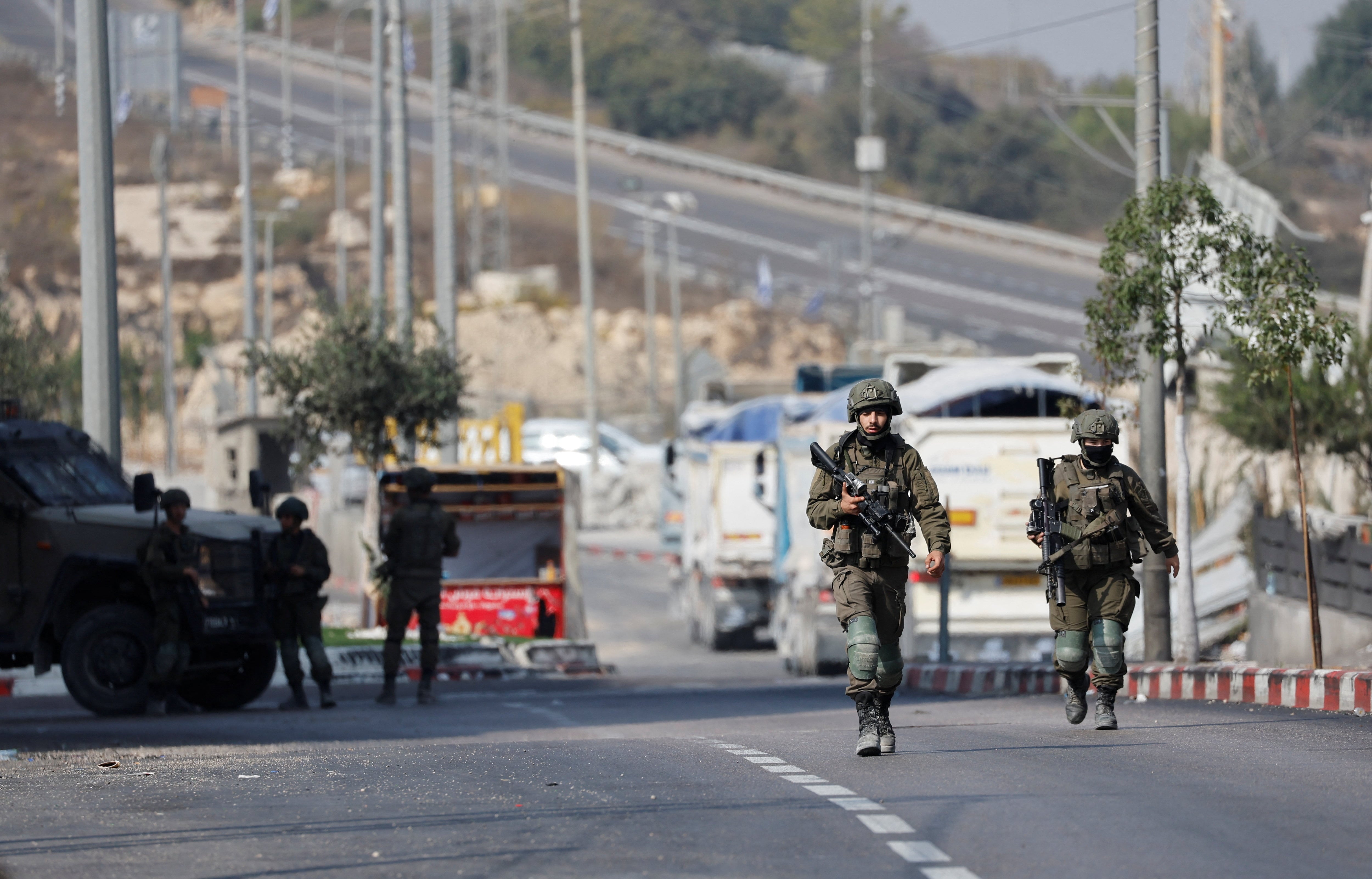 Israeli soldiers block a road during an operation in the occupied West Bank. Reuters