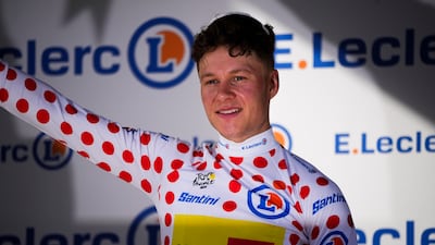 Norway's Jonas Abrahamsen, wearing the best climber's polka dot jersey, celebrates on the podium. AP