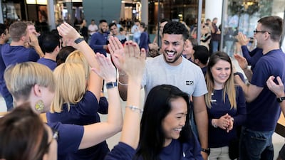 Employees welcome the first person to enter an Apple store during the launch of the new iPhone X at Dubai Mall. Mahmoud Khaled / EPA