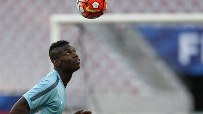 France's Pual Pogba goes for a header during training on Wednesday ahead of a Thursday friendly against Armenia. France will host Euro 2016 and thus are already qualified. Valery Hache / AFP