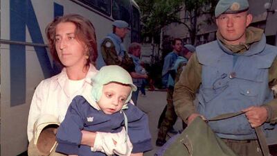 Amra Husic carries her one-year-old child Jasmin, who was suffering from malnutrition, into Sarajevo's Kosevo hospital after both were evacuated alongside 20 other people by Norwegian UN soldiers out of the eastern Muslim enclave of Srebrenica, Bosnia and Herzegovina, May 4, 1995. EPA