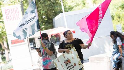 Fans and supporters of Britney Spears wave 'Free Britney' flags as they gather outside the Los Angeles County Courthouse. AFP