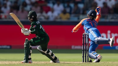 India's wicketkeeper Richa Ghosh, right, dives to takes the catch to remove Pakistan captain Fatima Sana. AP