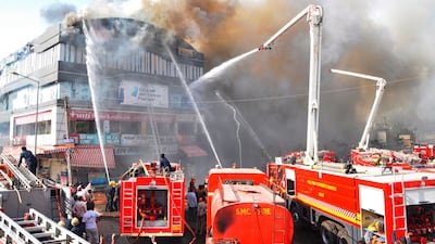 Indian firefighters try to control a major fire in a building housing a college, in Surat. AFP