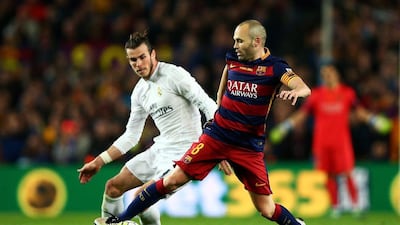 Barcelona captain Andres Iniesta, right, in action against Real Madrid during the clasico defeat on Saturday. Paul Gilham / Getty Images
