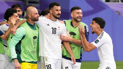 Iraq's Aymen Hussein, centre, celebrates after scoring his side's second goal. AP