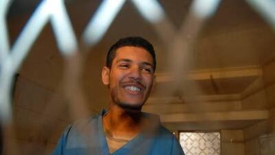 Hisham Mohammed Assem, a Yemeni accused of killing a Frenchman, sits behind the bars at the start of a court hearing in Sana'a.