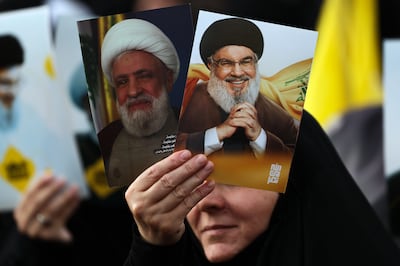 Images of Hezbollah leader Naim Qassem, left, and his predecessor, the late Hassan Nasrallah, are displayed at a gathering to mark Resistance and Liberation Day' in Beirut's southern suburbs. EPA