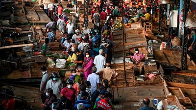 People wearing facemasks buy supplies at a crowded vegetable market at Piliyandala on the outskirts of Sri Lanka's capital city Colombo. AFP