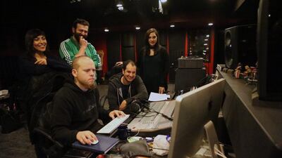 The team working with producer Chris Mullender in the studio where they record their Arabic songs for Adam Wa Mishmimish. Salah Malkawi for The National