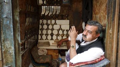 A Yemeni man selling daggers chews qat as he sits inside at his stall. REUTERS/Khaled Abdullah