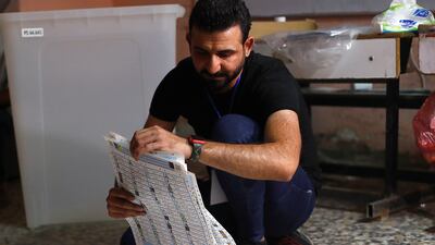 An election worker counts ballots after polls close. Parliamentary elections were held months ahead of schedule in response to a popular uprising against corruption and mismanagement. AP