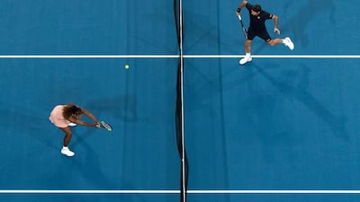 Serena Williams, left, (L) of the USA and Roger Federer of Switzerland in action during the mixed doubles match. EPA