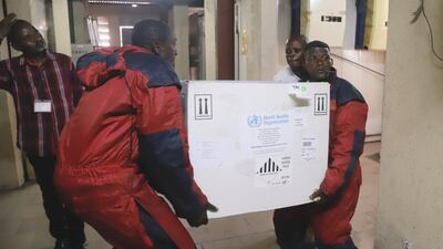 Congolese health workers carry the first batch of experimental Ebola vaccines to arrive in Kinshasa, capital of the Democratic Republic of Congo, on May 16, 2018. Kenny Katombe / Reuters