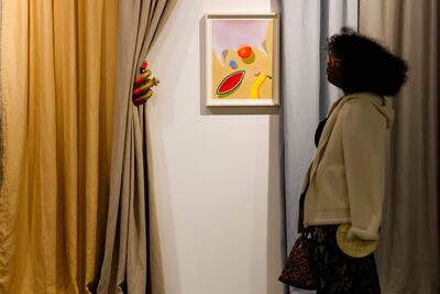 A visitor looks at an artwork on display at the 21st edition of Art Basel Miami Beach. Photo: AFP