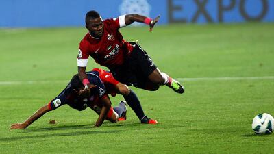 Ahmed Hassan of Al Shaab and Al Ahli's Ismaeel Al Hamadi clash for possession. Satish Kumar / The National