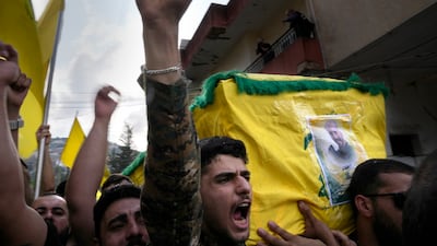 A Hezbollah fighter carries the coffin of his comrade who was killed by Israeli shelling in Kherbet Selem, south Lebanon. AP Photo