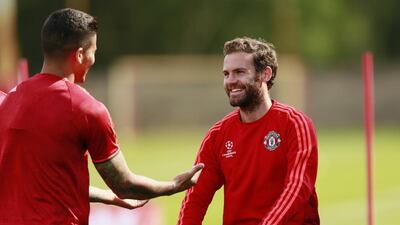 Manchester United's Juan Mata, right, and Marcos Rojo during training. Reuters / Jason Cairnduff