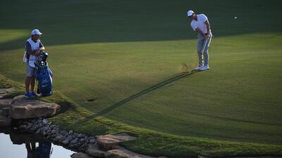 Rory McIlroy of Northern Ireland hits his approach to the 18th green. Ross Kinnaird / Getty Images