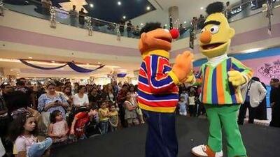 Children watch as Sesame Street characters perform at the Marina Mall.