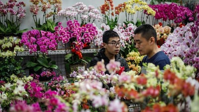 Chinese men choose flowers at a market on the eve of Valentine's Day in Beijing. Roman Pilipey / EPA