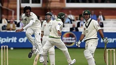 Mohammad Aamer, left, of Pakistan celebrates taking the wicket of Ricky Ponting, the Australia captain, at Lord's yesterday.